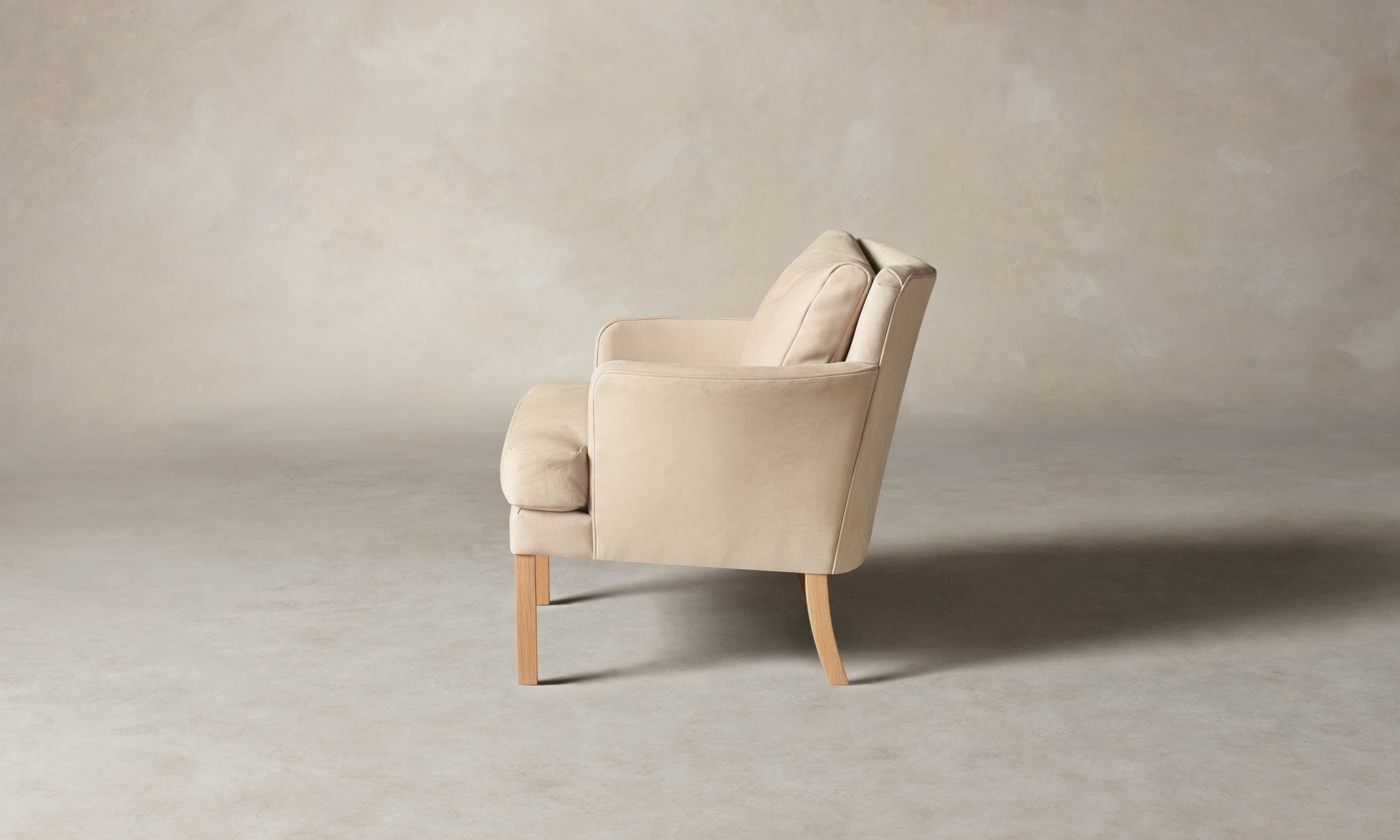 kaye leather accent chair in grey nubuck leather with wooden legs, side view