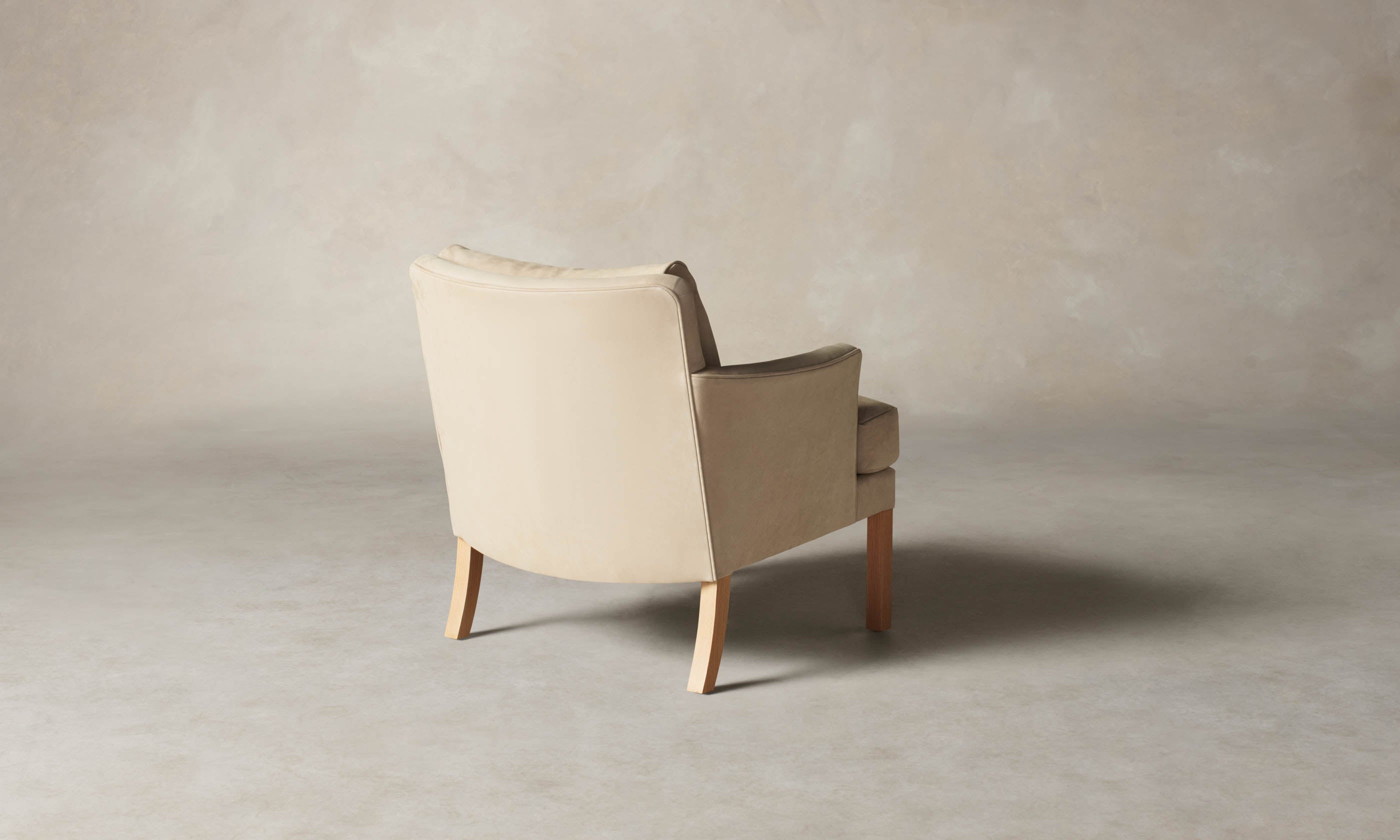 kaye leather accent chair in grey nubuck leather with wooden legs, angle view