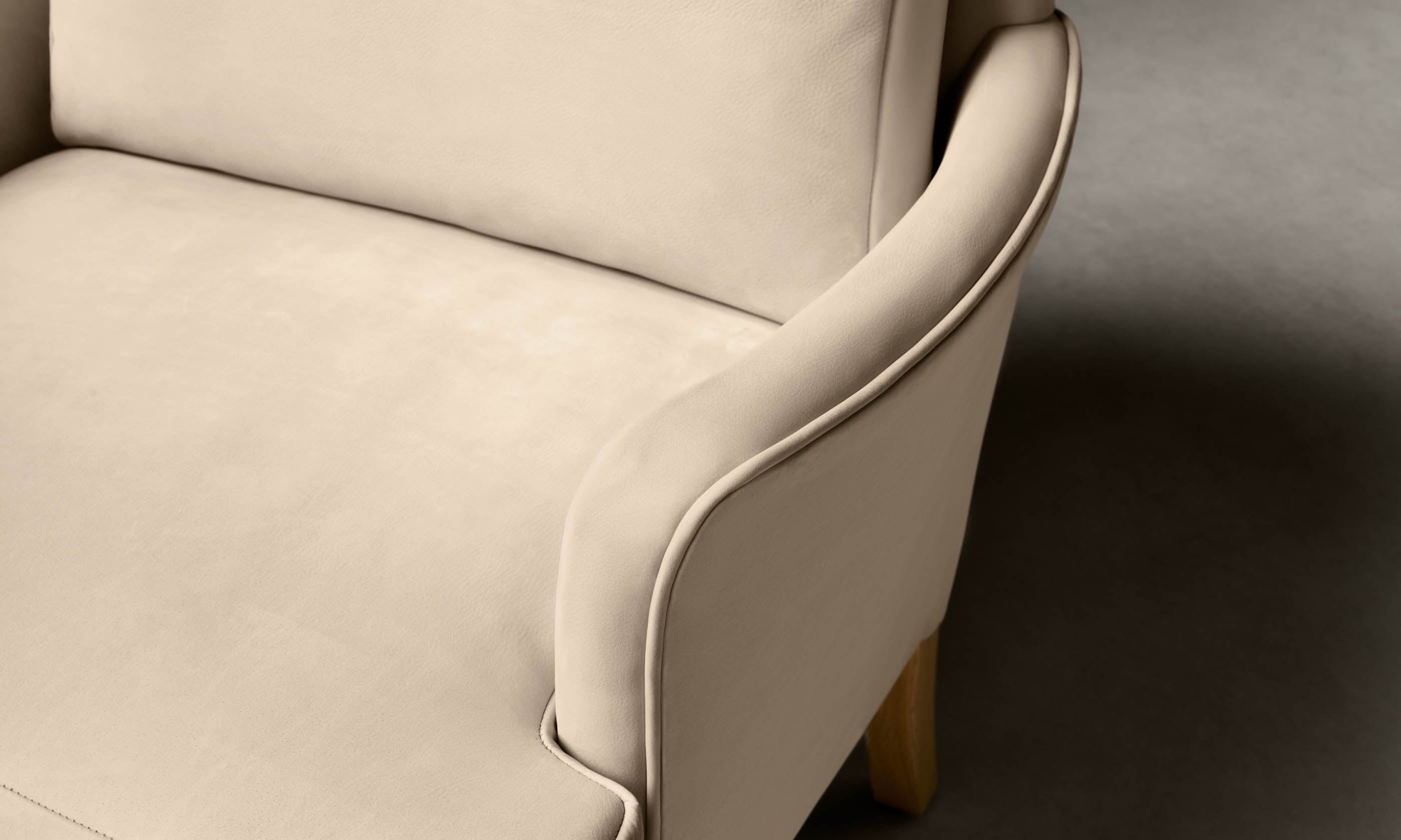 kaye leather accent chair in grey nubuck leather with wooden legs, seat close up