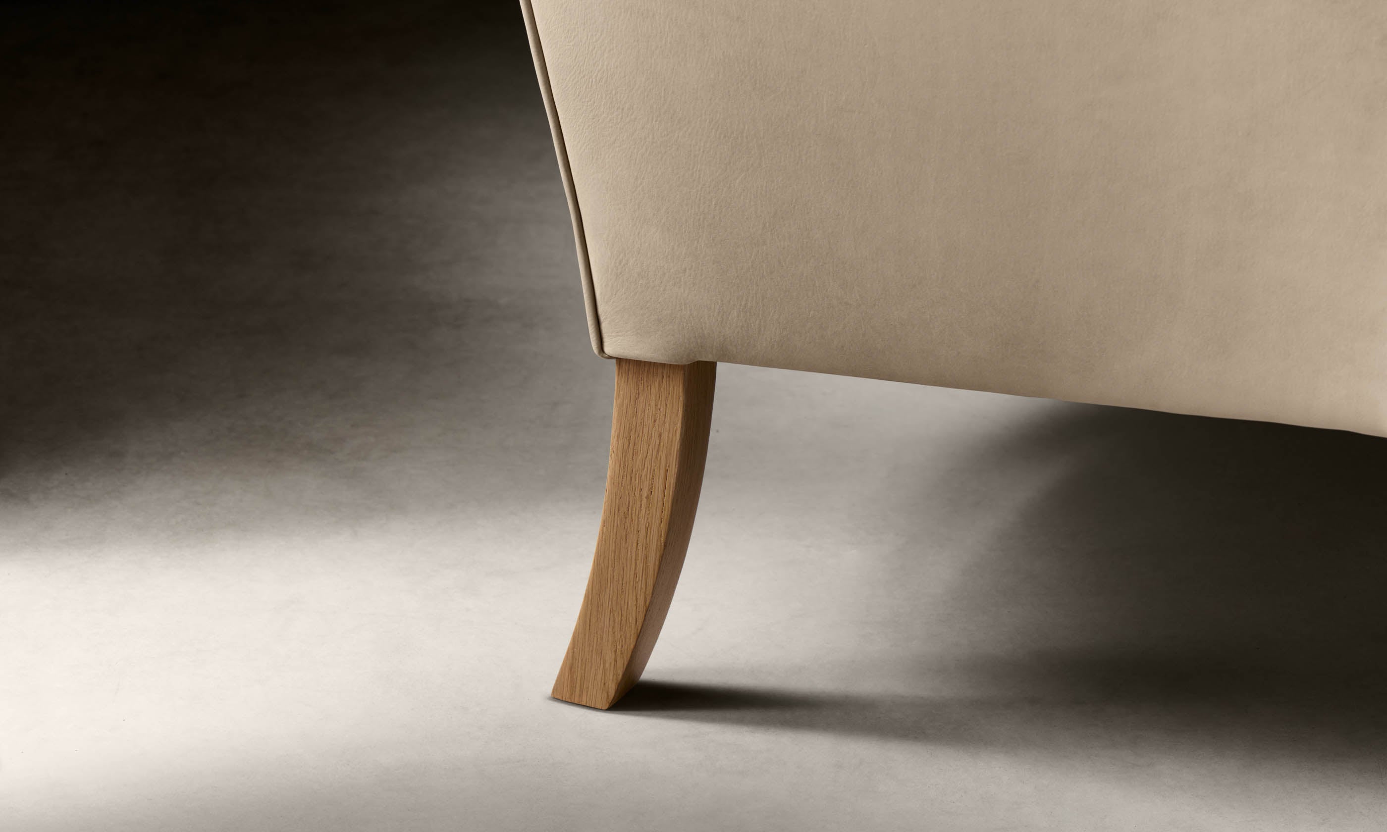 kaye leather accent chair in grey nubuck leather with wooden legs, leg close up