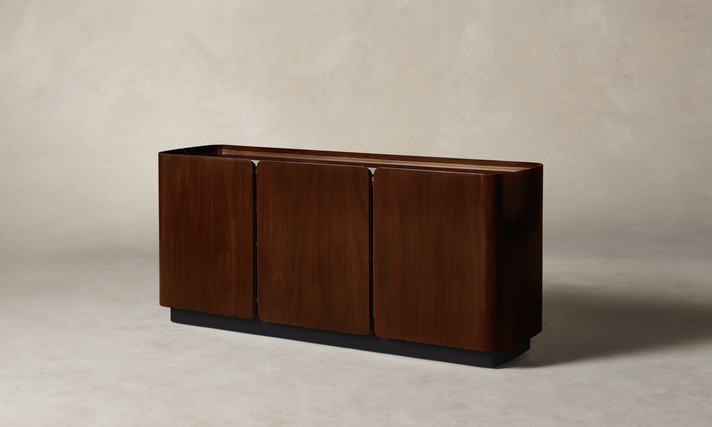 sabine dark oak wood sideboard with three doors and a glass top, angle view