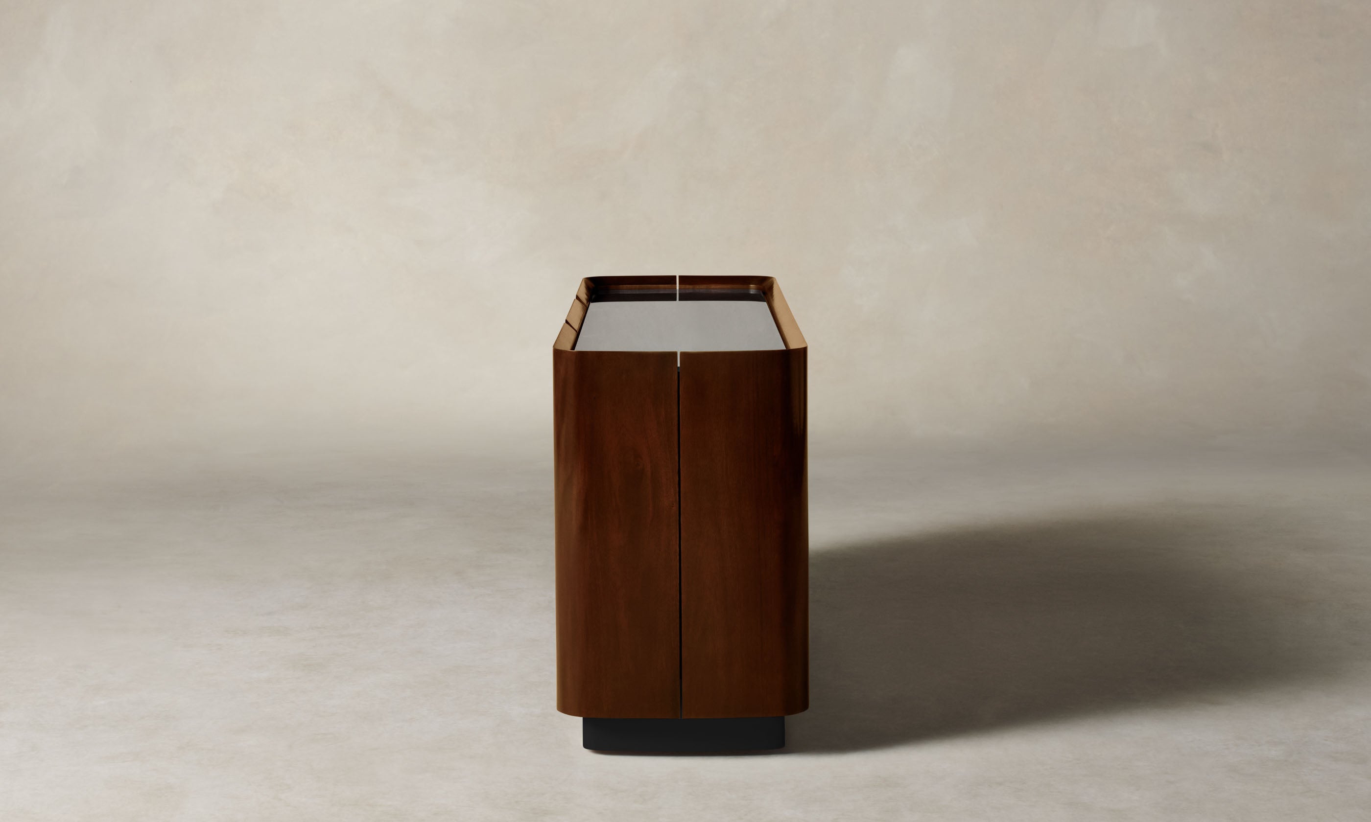 sabine dark oak wood sideboard with three doors and a glass top, side view