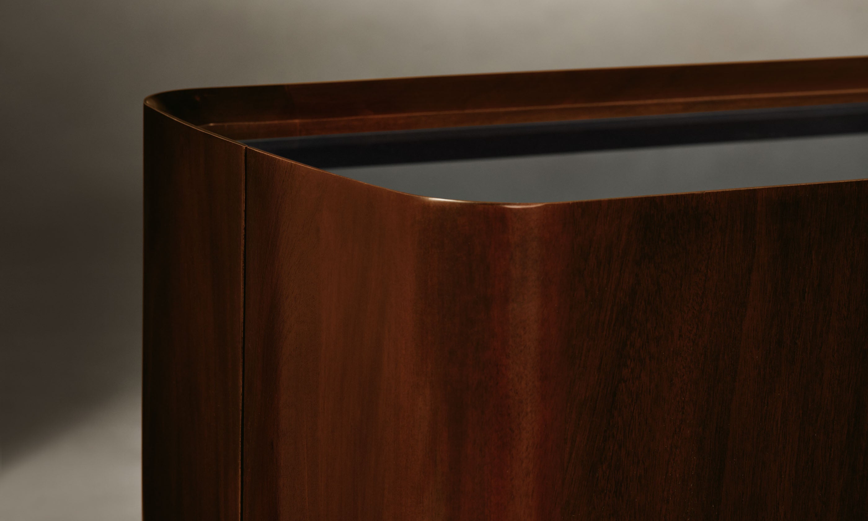 sabine dark oak wood sideboard with three doors and a black opaque glass top