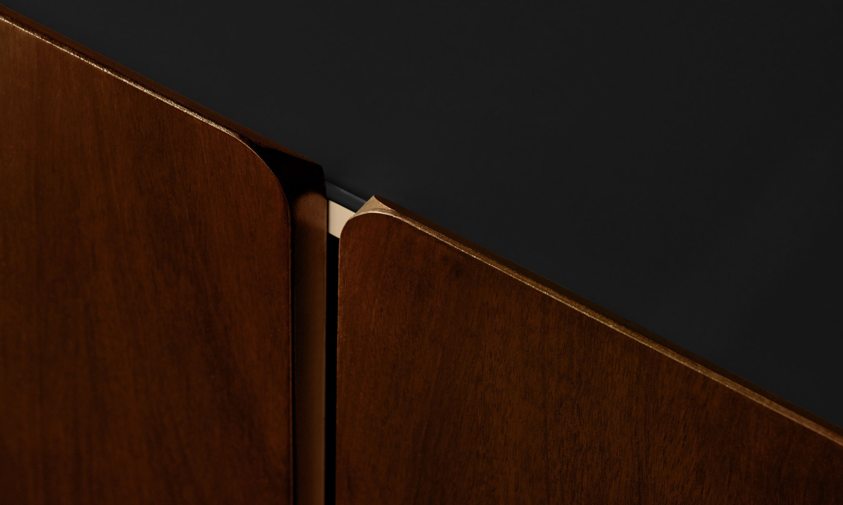 sabine dark oak wood sideboard with 4 doors and a black glass top, close up