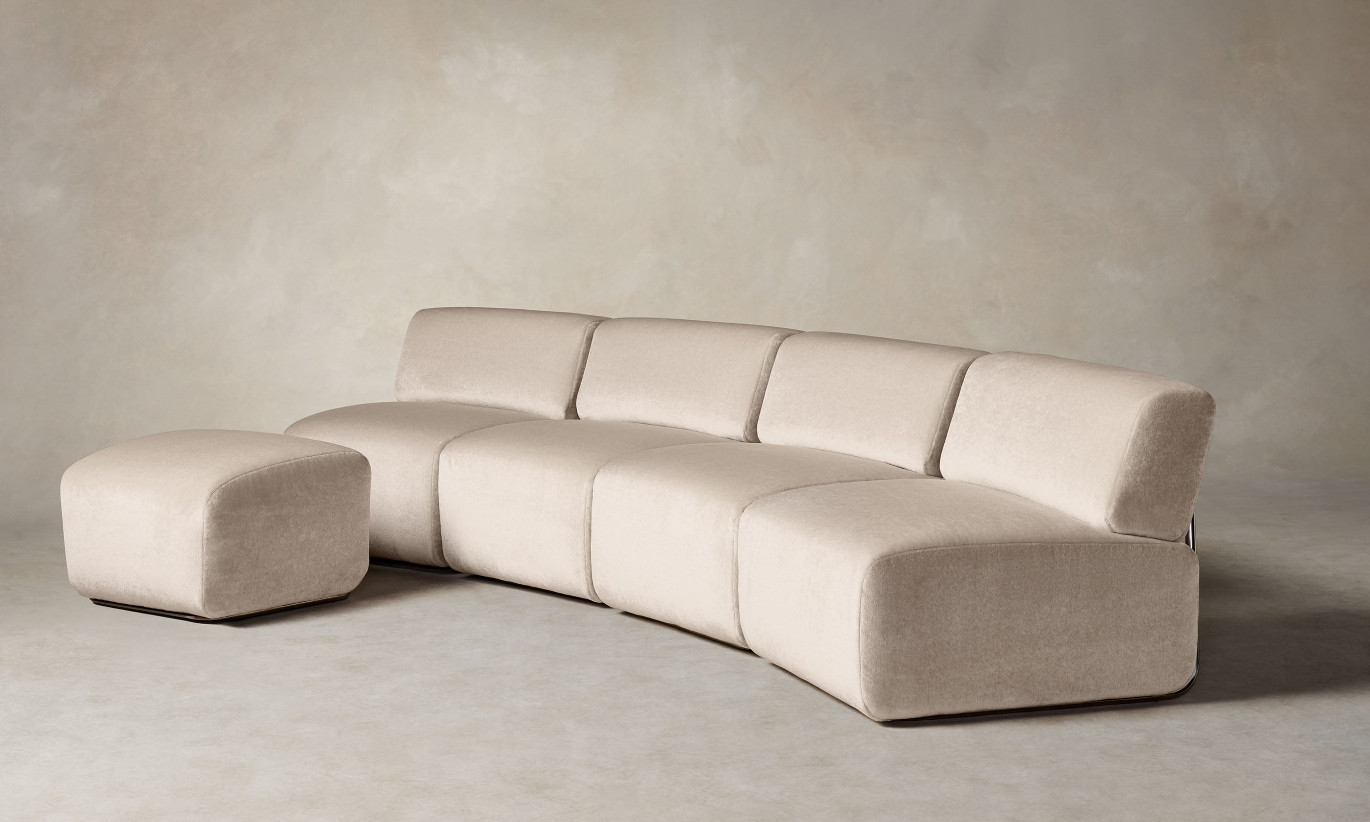 miles modular sectional in off-white mohair with curved shape and an ottoman