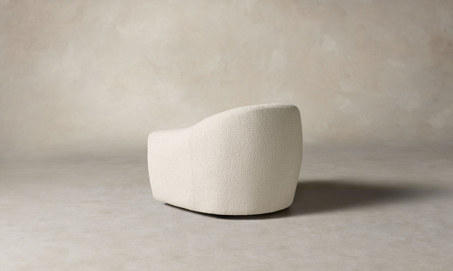 oliver accent chair in white boucle with curved back, angle view