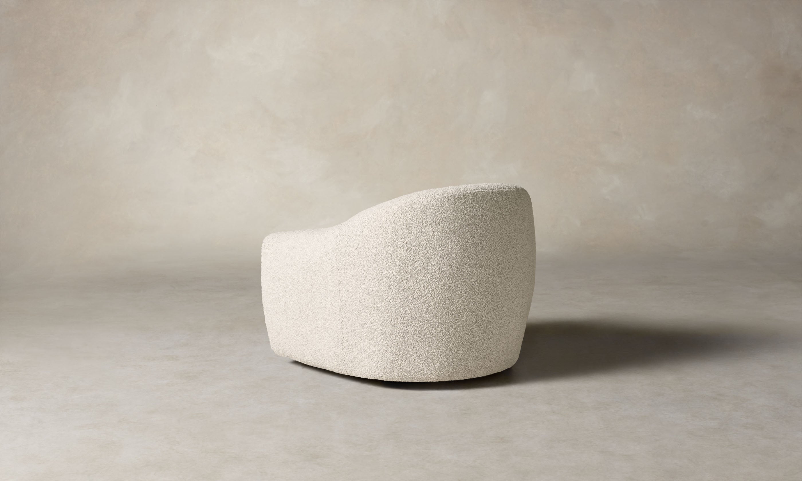 oliver accent chair in white boucle with curved back, angle view