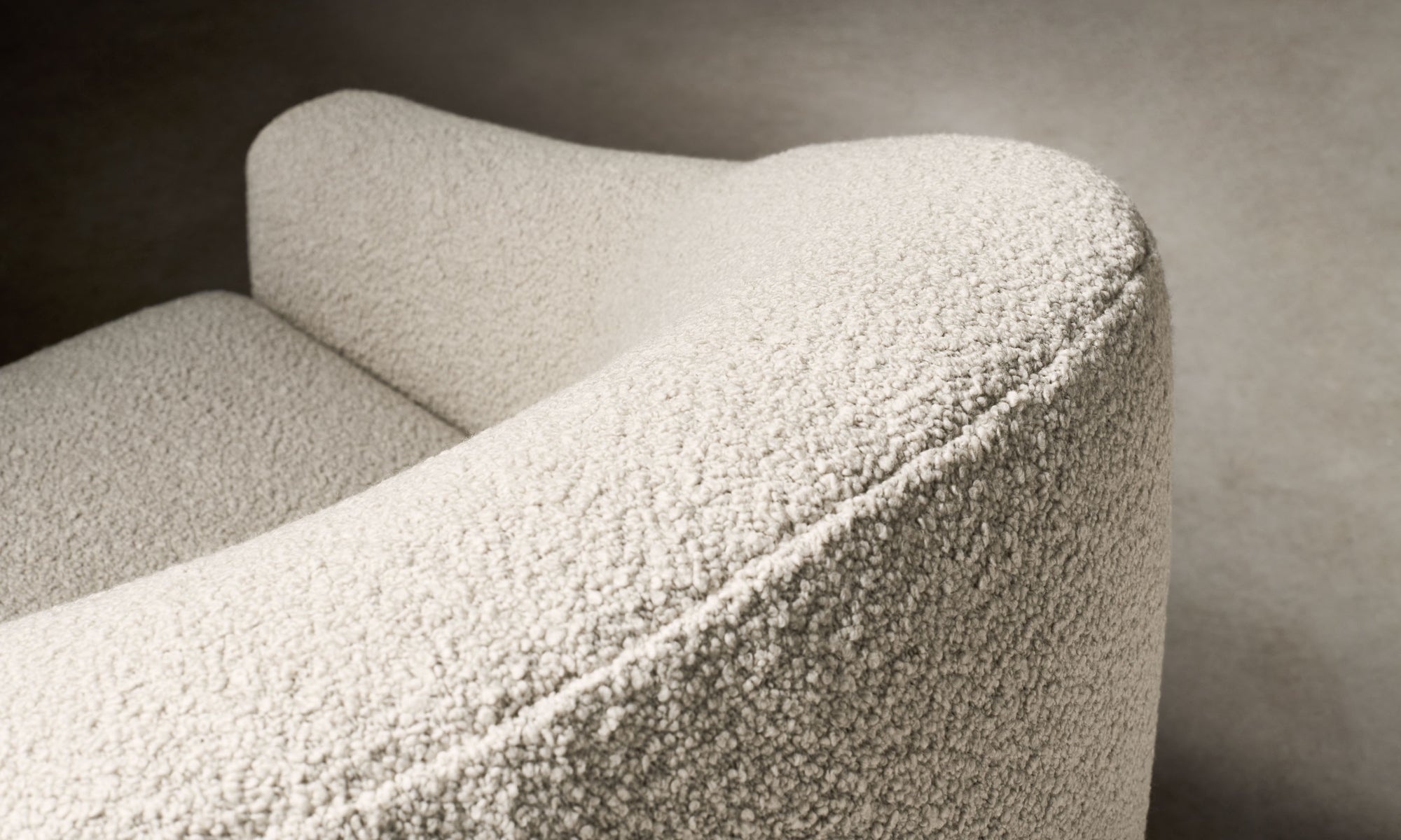 oliver accent chair in white boucle with curved back, close up view