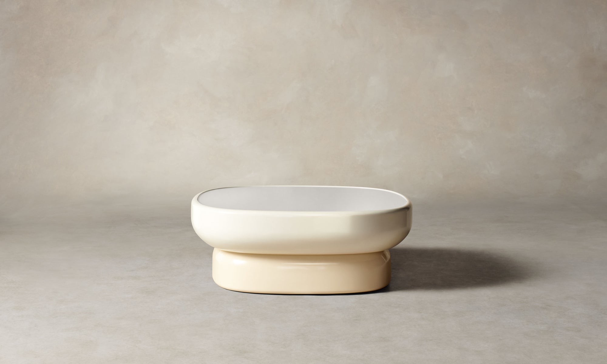 emile oval glass coffee table with lacquered beige base and white opaque glass top in art deco style