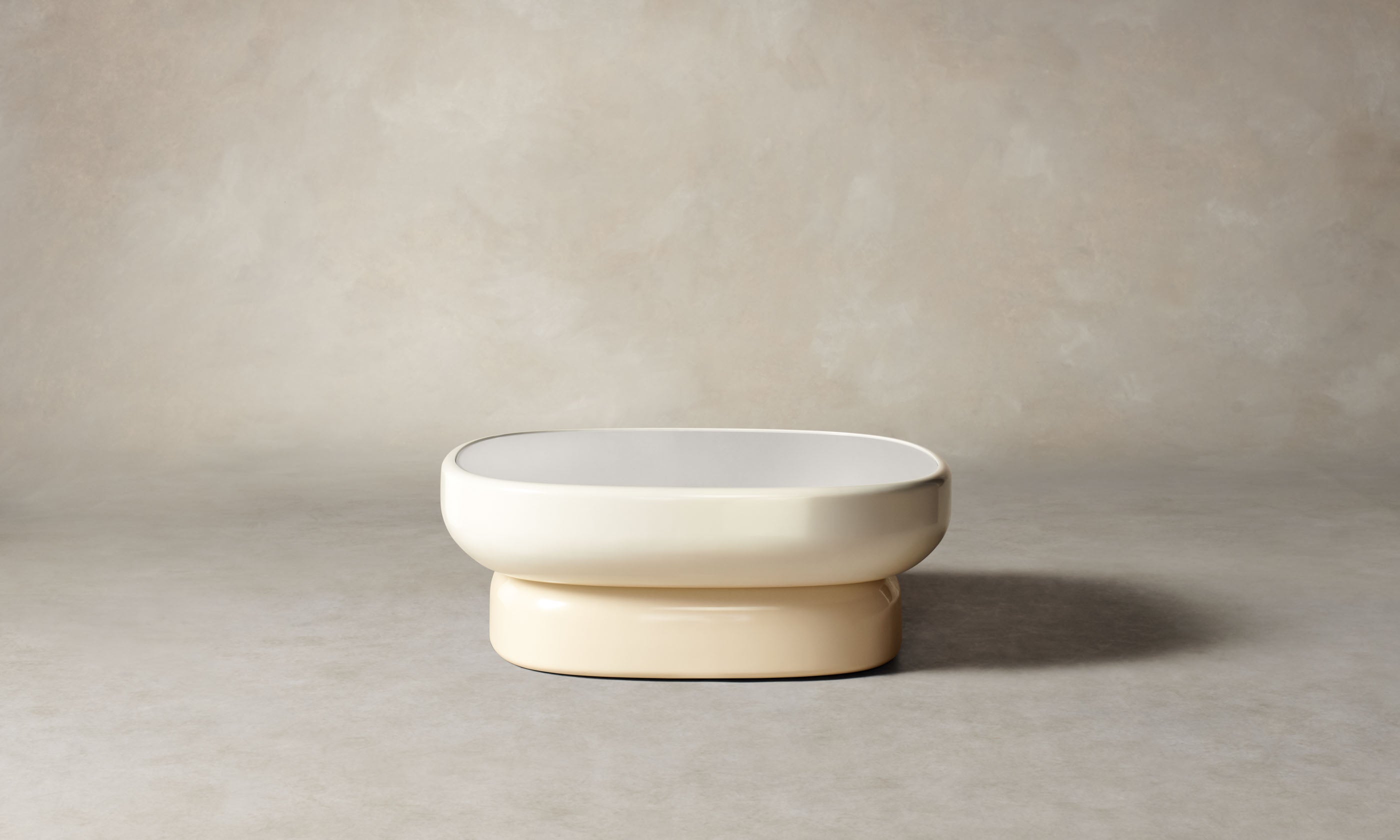 emile oval glass coffee table with lacquered beige base and white opaque glass top in art deco style