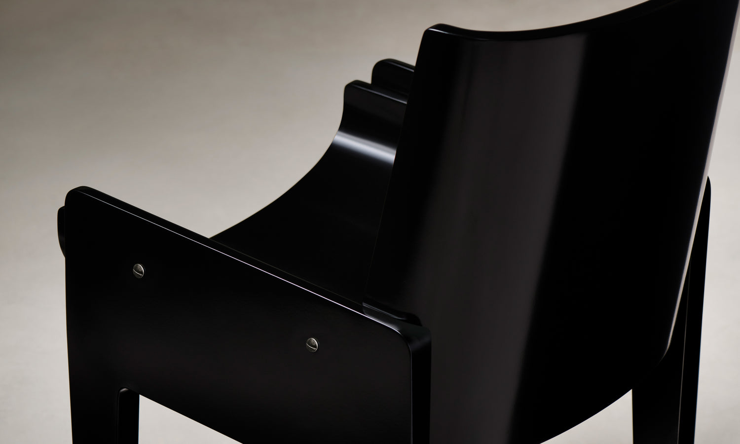leon black lacquered wood dining chair, close up arm view