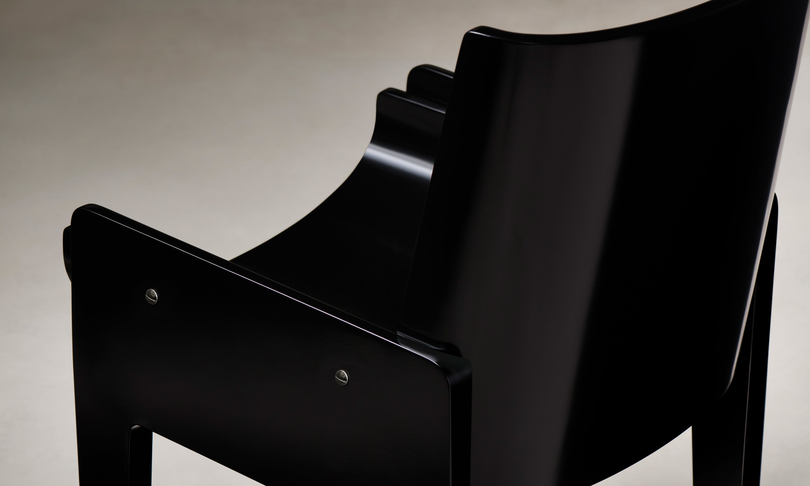 leon black lacquered wood dining chair, close up arm view