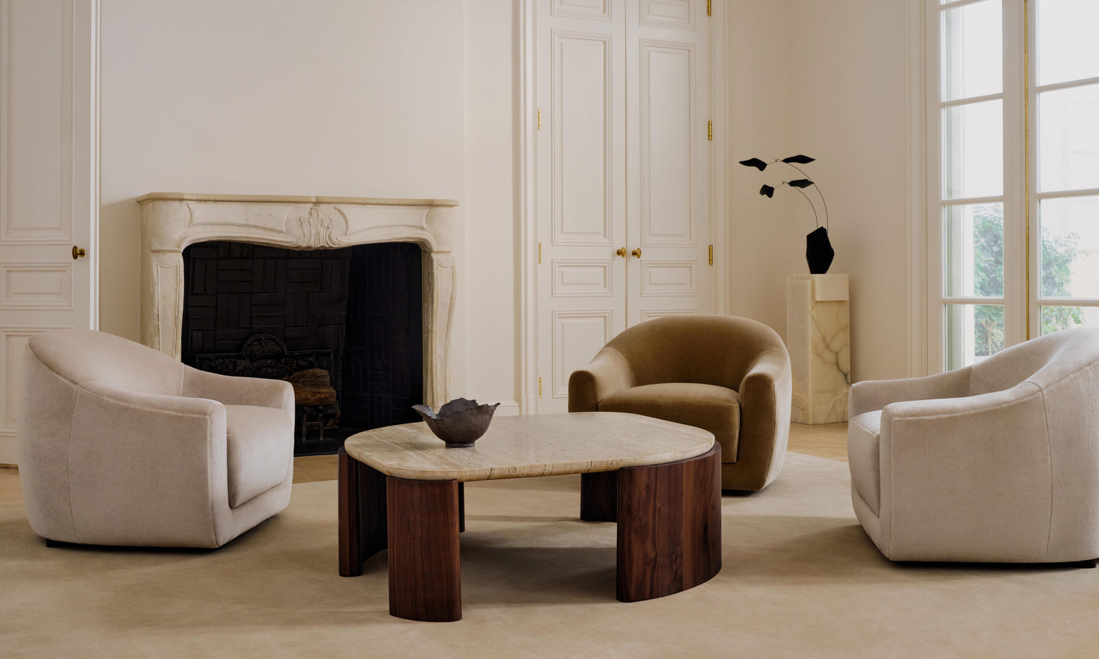 travertine stone top coffee table and accent chairs in a modern living room