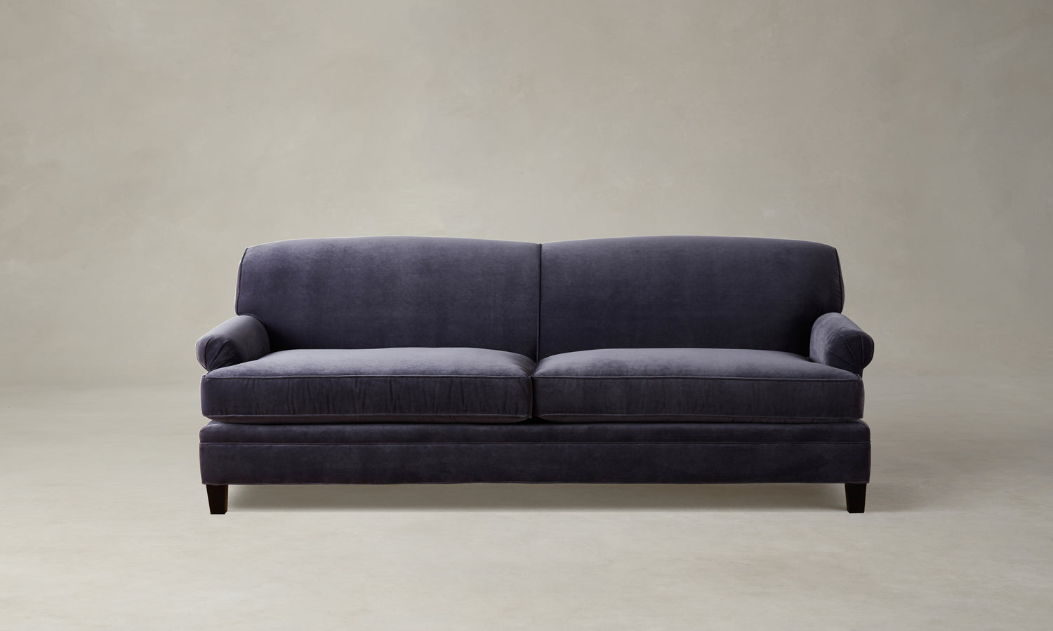 carmine sofa in purple velvet with pleated arms and tapered wooden legs