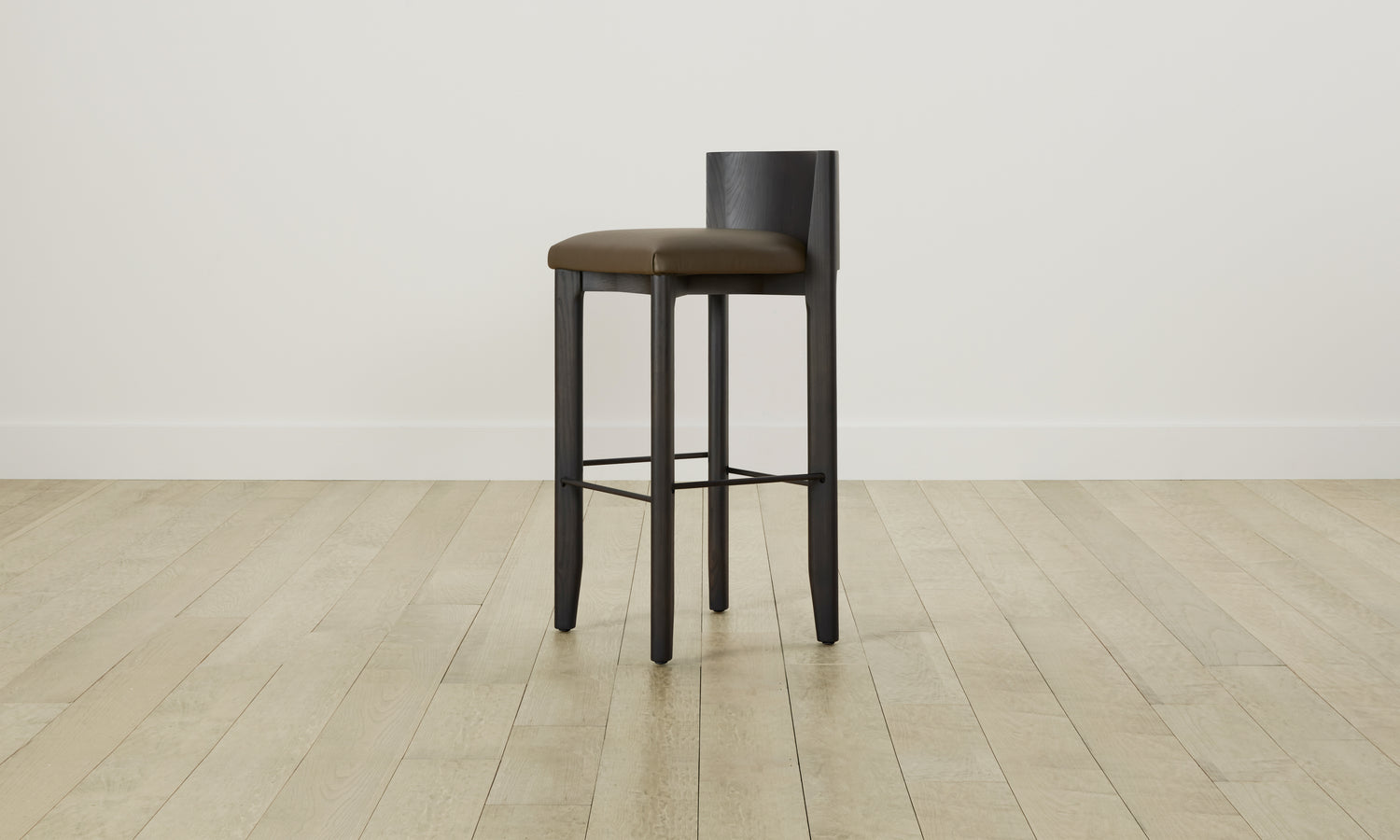 delancey barstool in black ash wood with truffle green leather seat with curved back