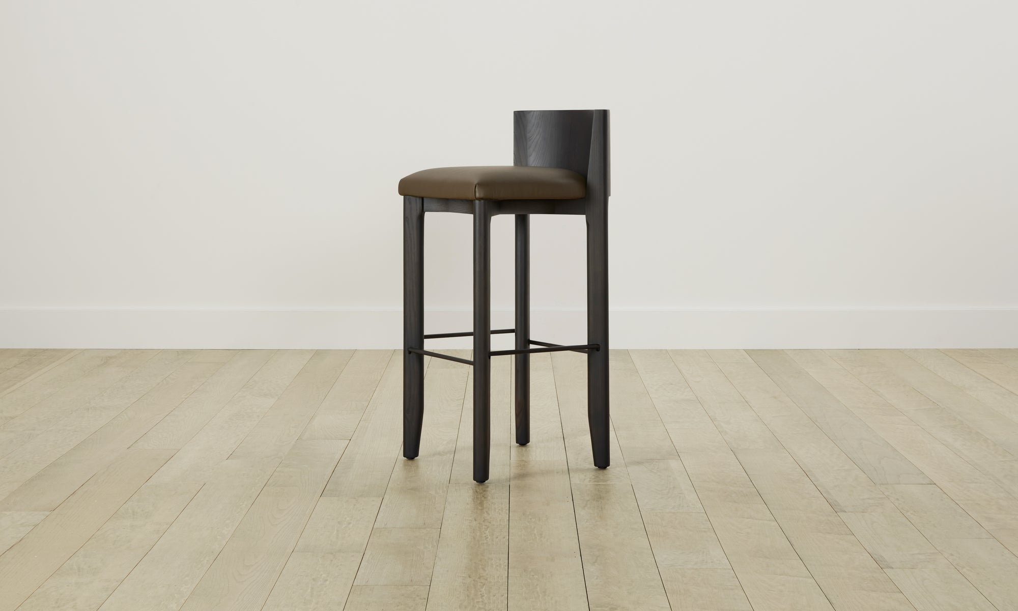 delancey barstool in black ash wood with truffle green leather seat with curved back