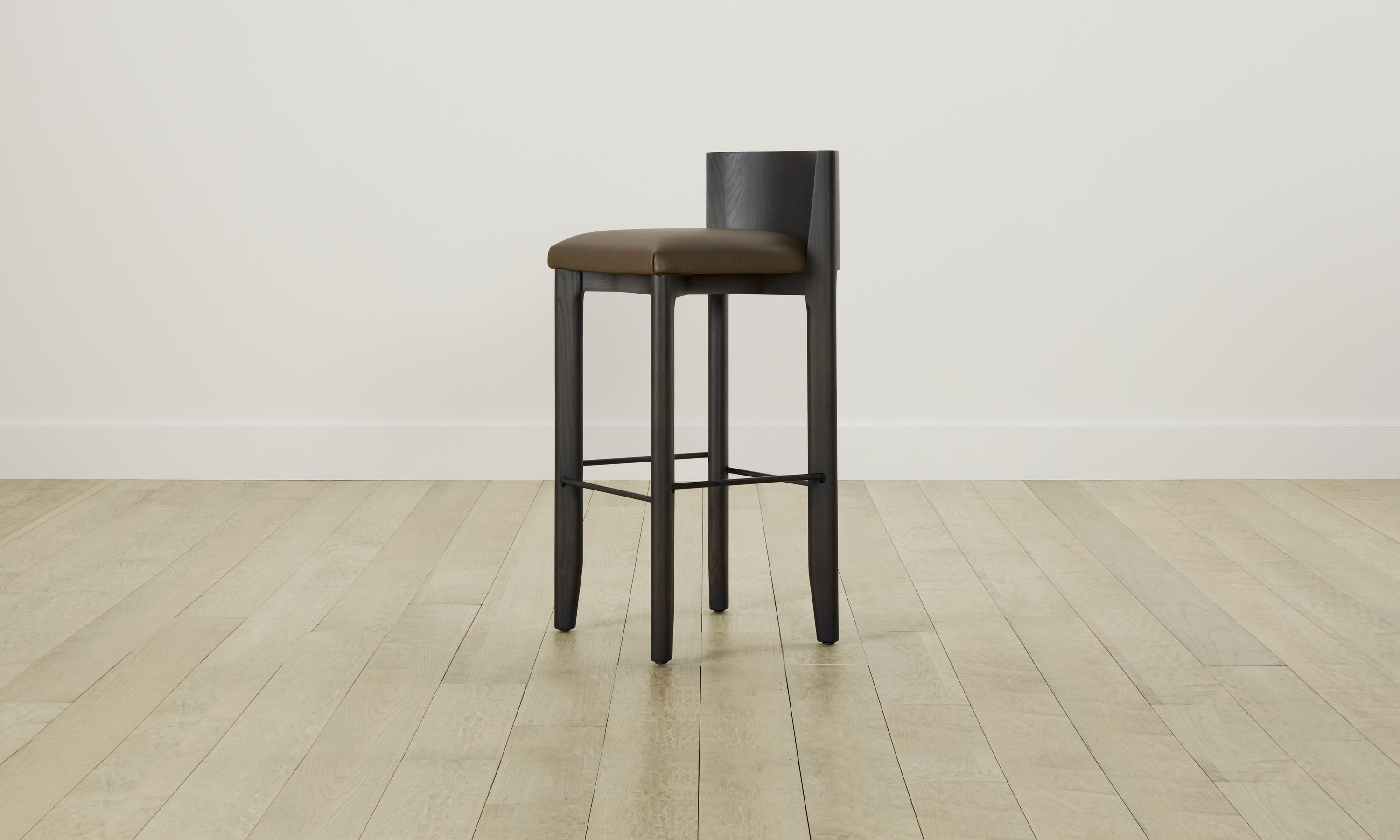delancey barstool in black ash wood with truffle green leather seat with curved back