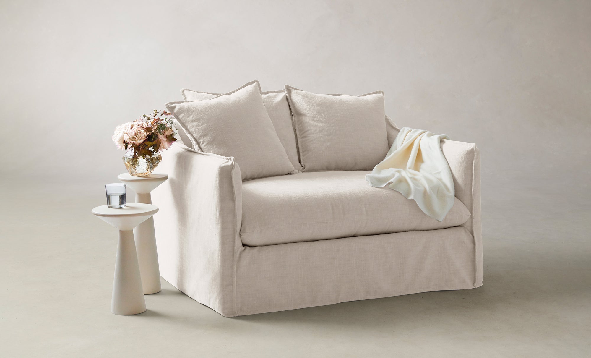 dune chair and half in white linen with cushions