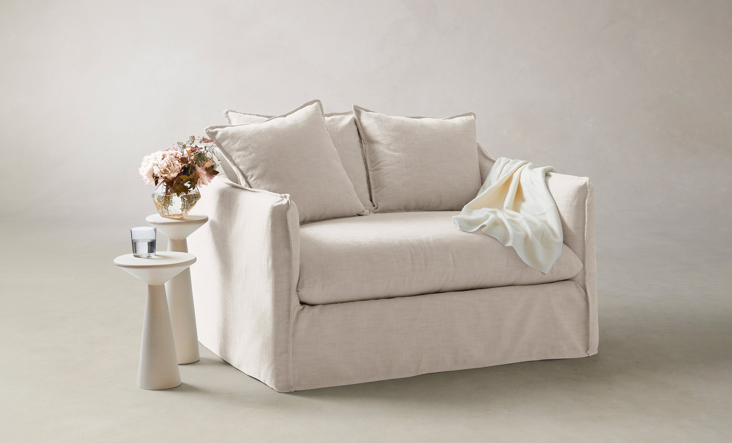 dune chair and half in white linen with cushions