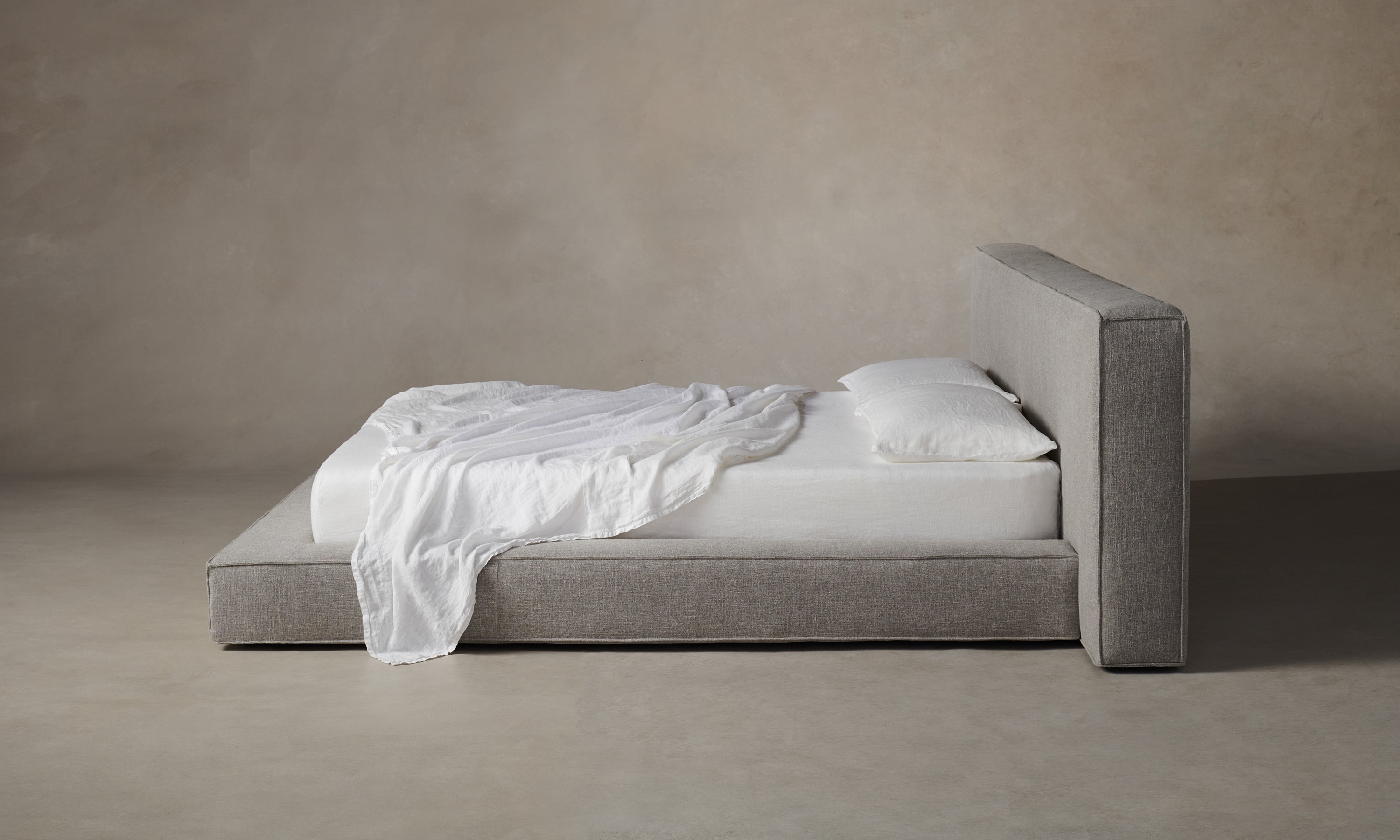 eldridge upholstered bed with cushion bed frame in grey linen - side view