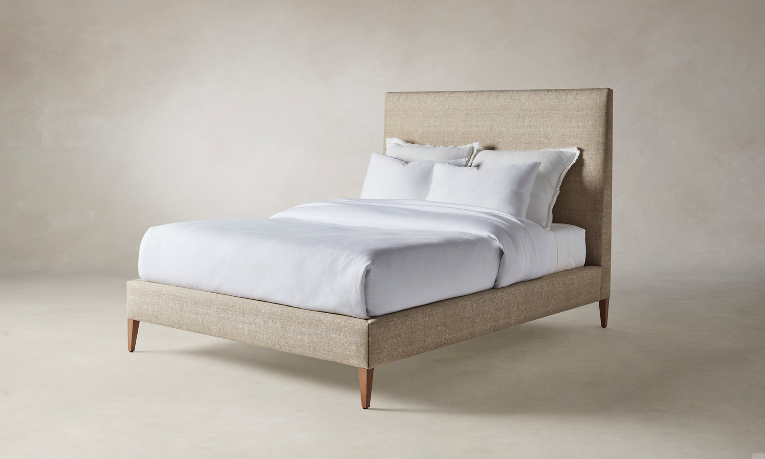 essex bed with upholstered headboard and frame in beige basketweave fabric with wooden legs