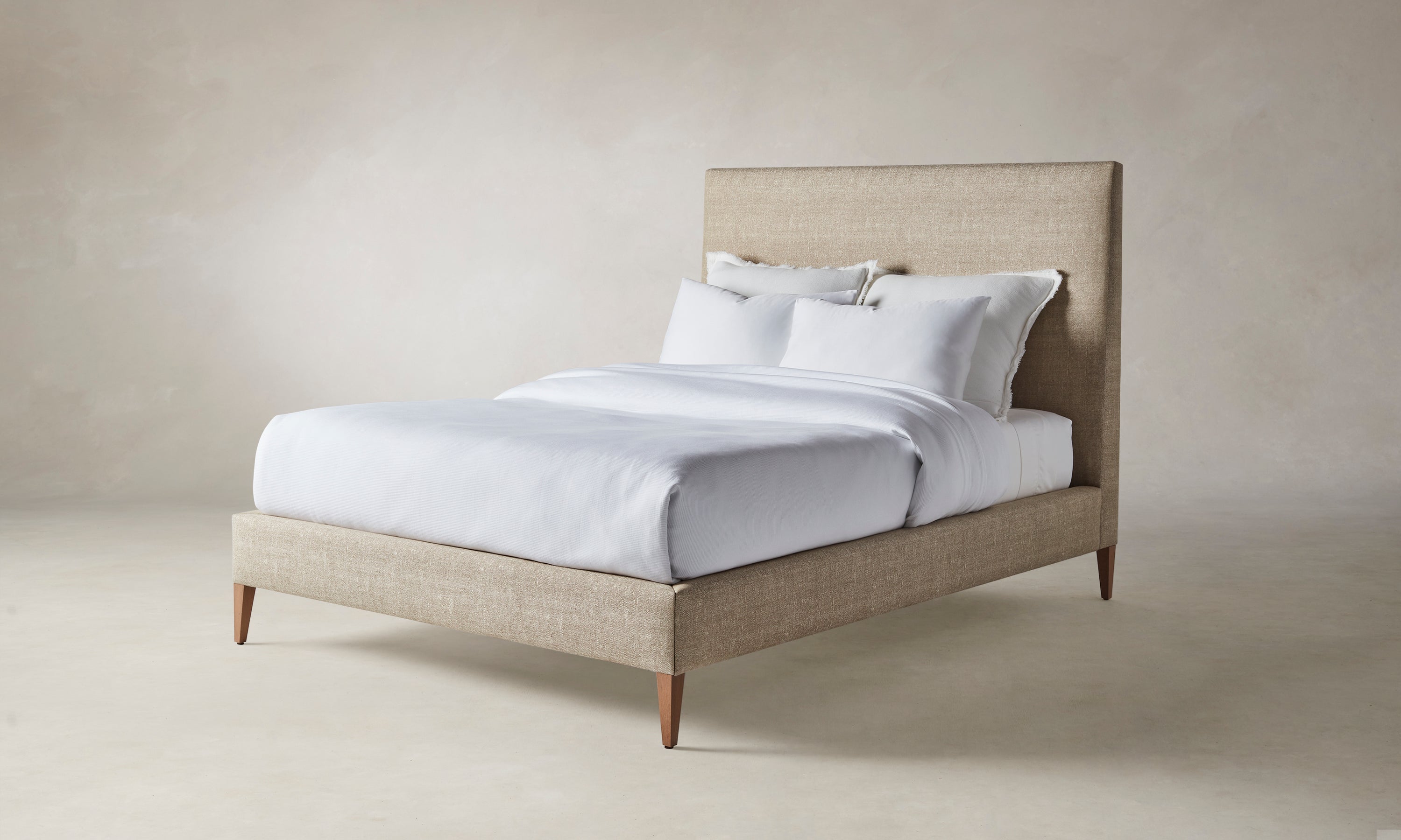 essex bed with upholstered headboard and frame in beige basketweave fabric with wooden legs
