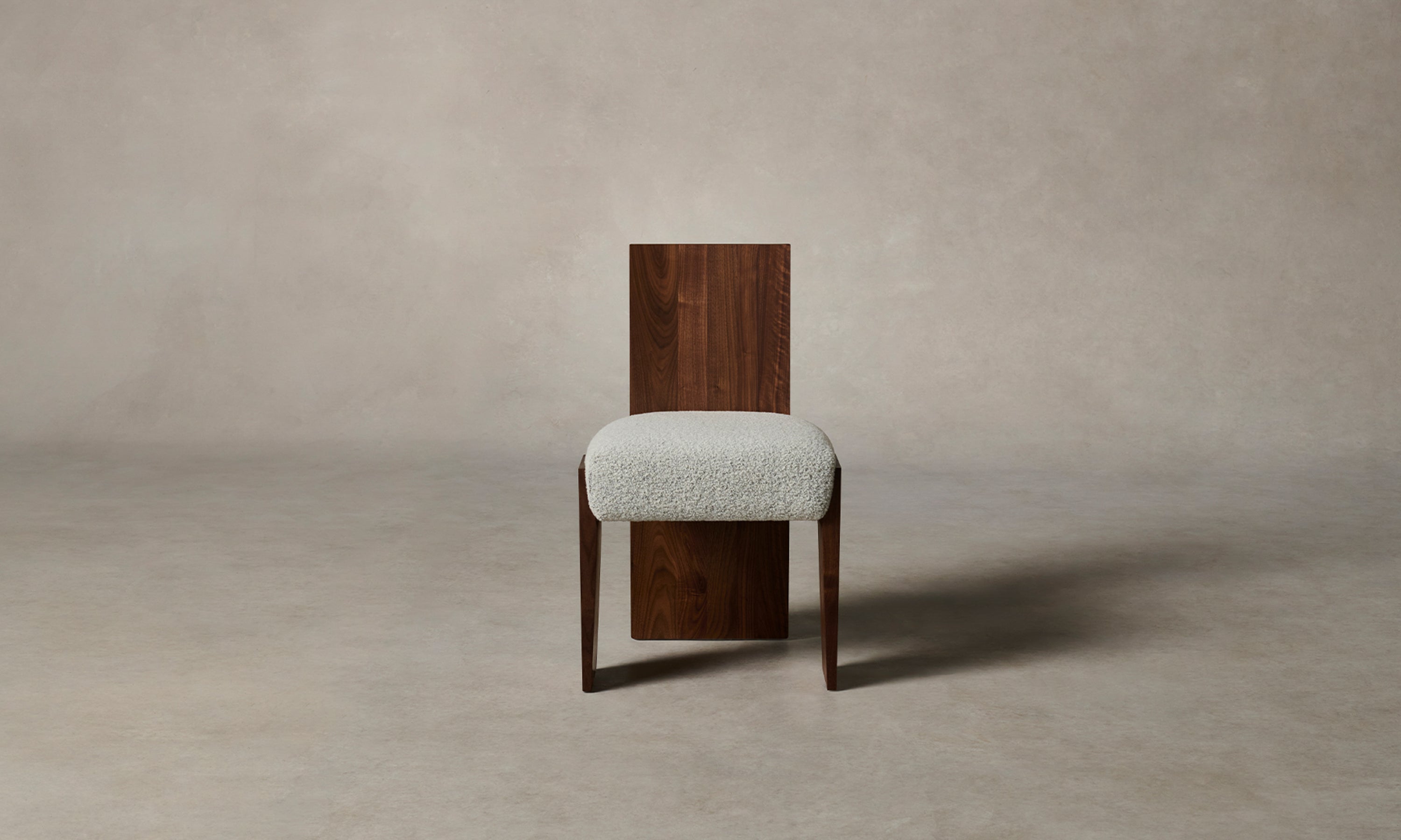 garrett dining chair in brown walnut wood and grey boucle fabric