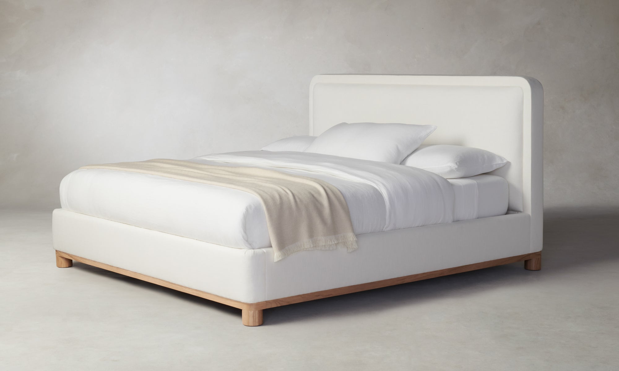 kent bed with upholstered frame and headboard in white linen with wood trim