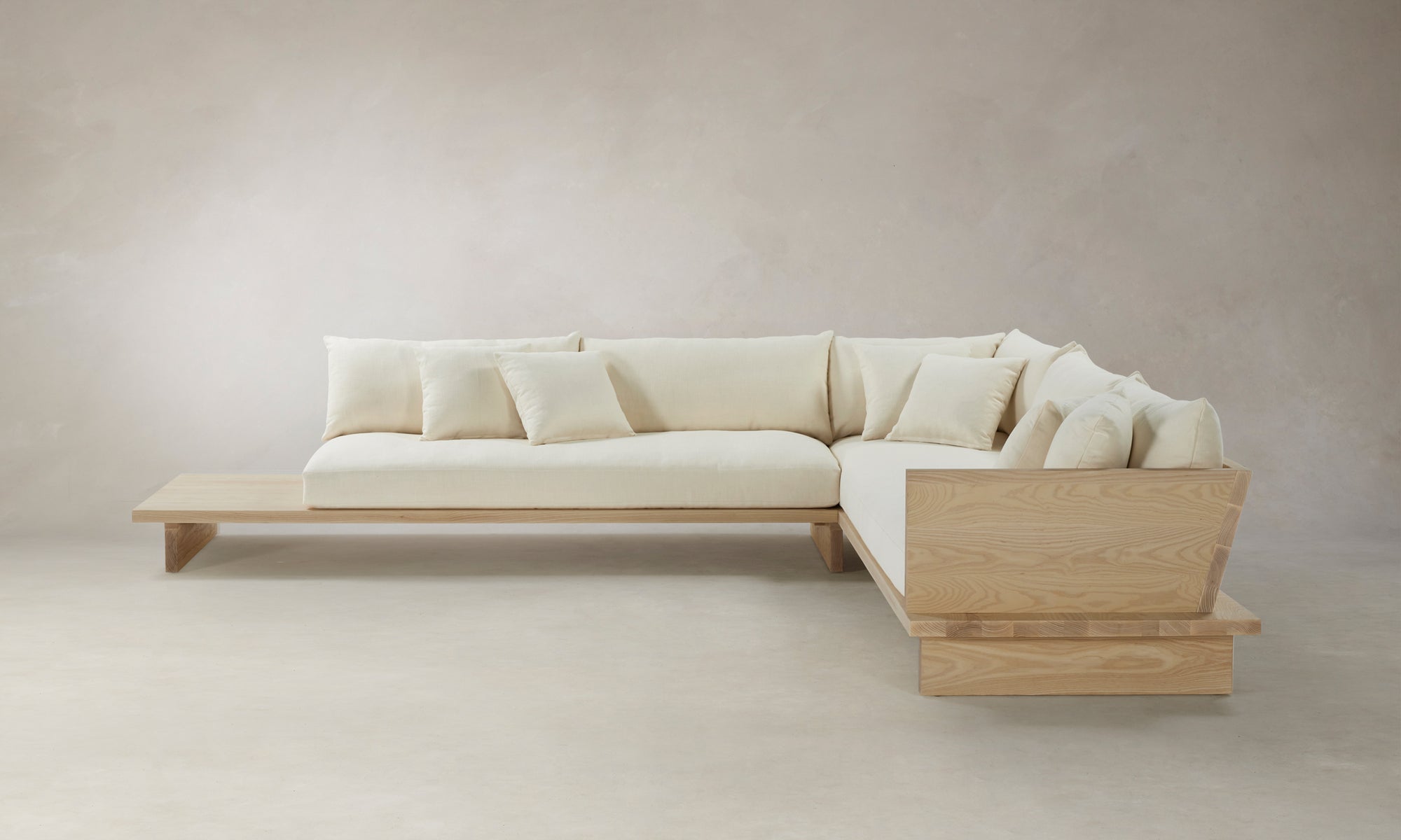 muir l-shaped sectional sofa with wooden shelf in white linen