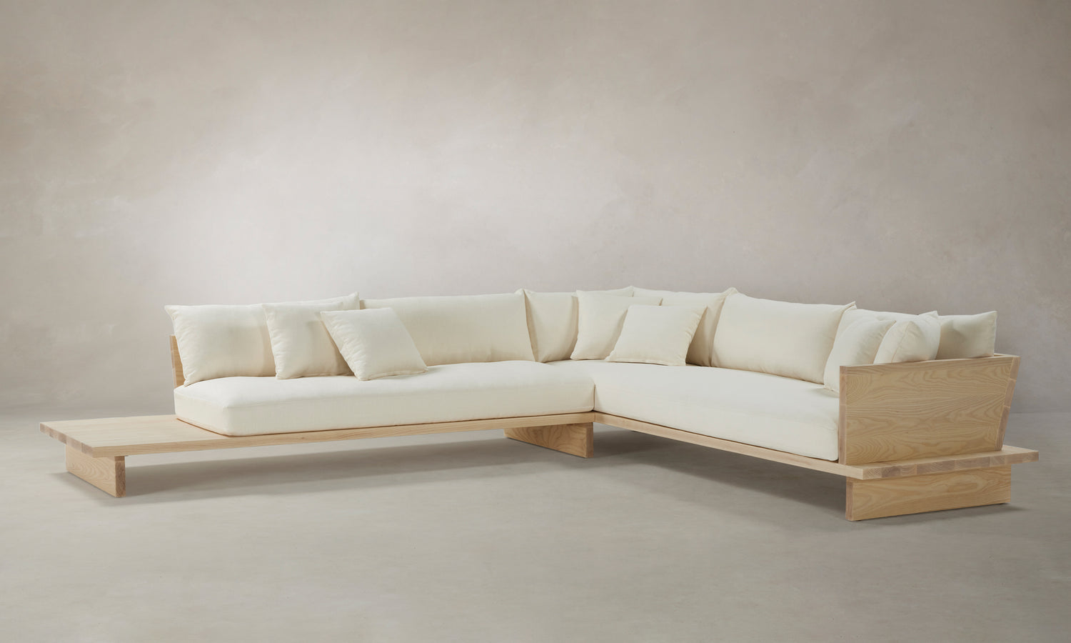 muir l-shaped sectional sofa with wooden shelf in white linen - angle view