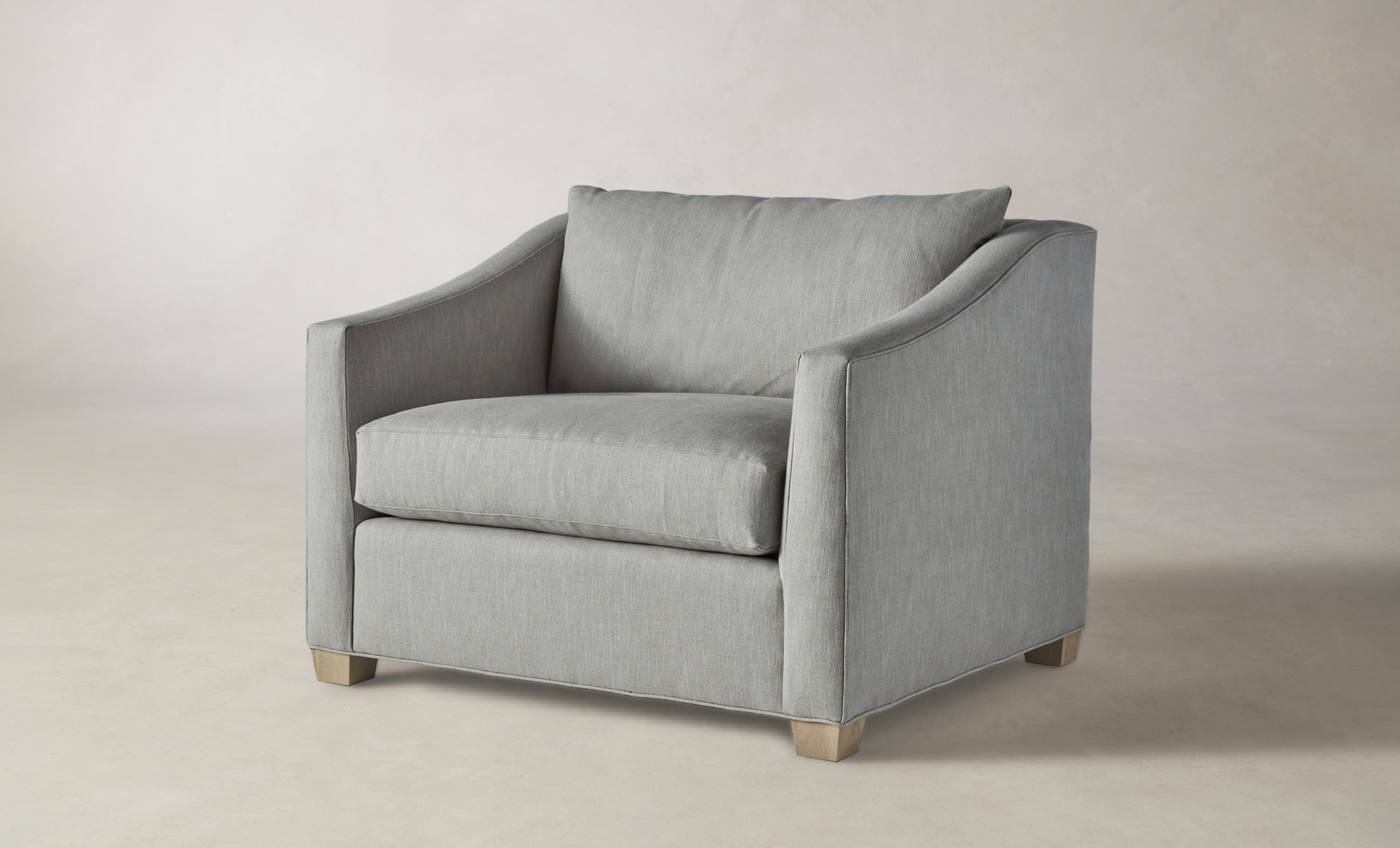 sullivan chair and a half in grey linen with wooden legs