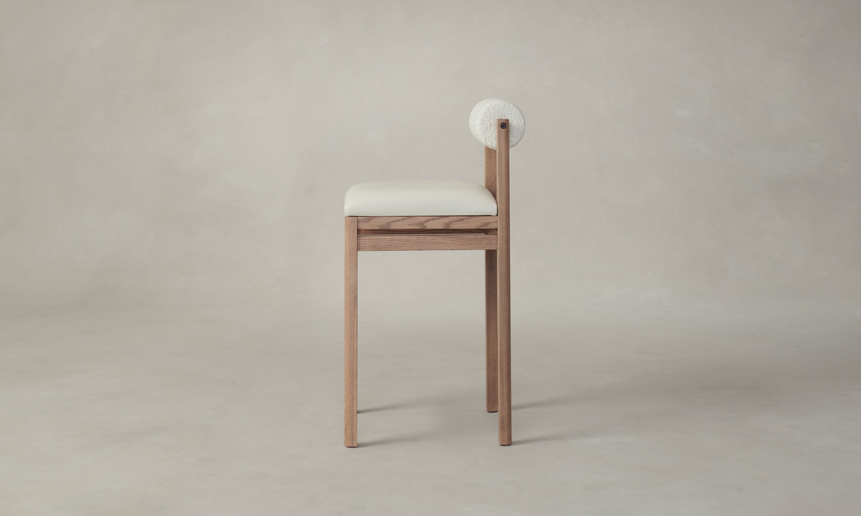 thayer wood barstool in oak with white leather seat and bolster back, side view