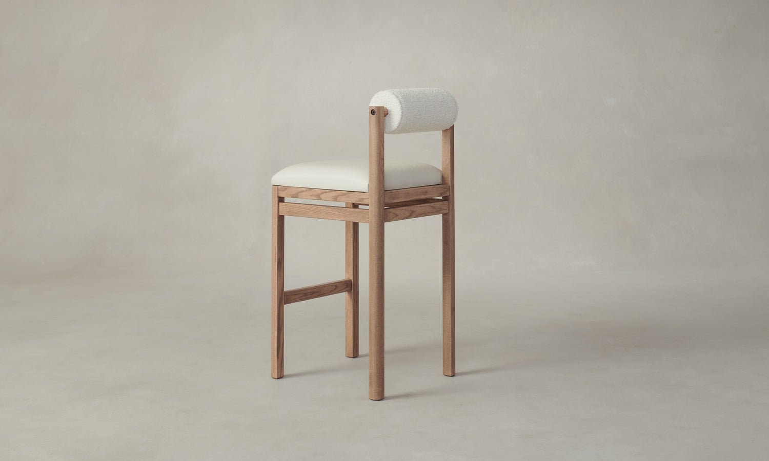 thayer wood barstool in oak with white leather seat and boucle bolster back, angle view