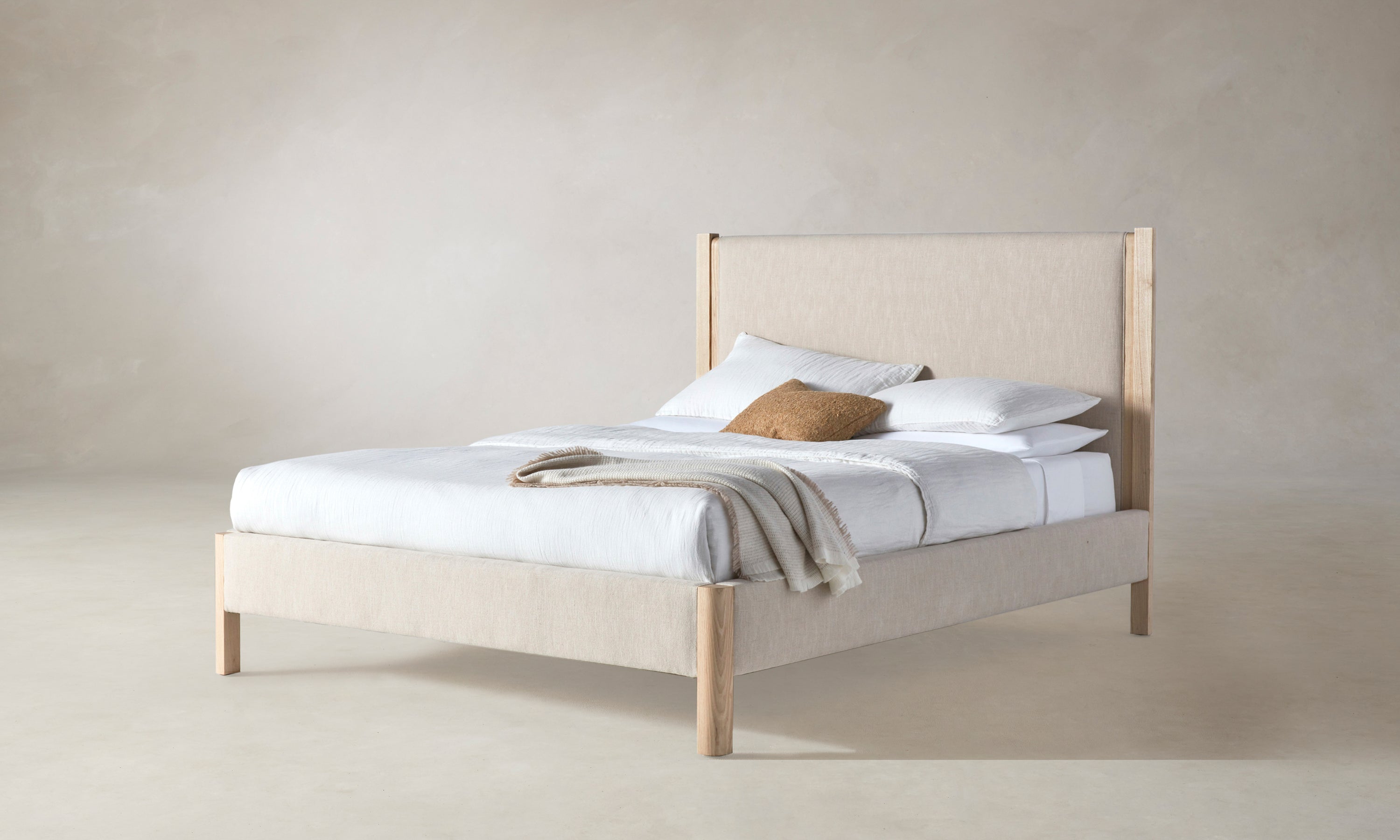 thompson upholstered bed in beige linen with ash wood legs