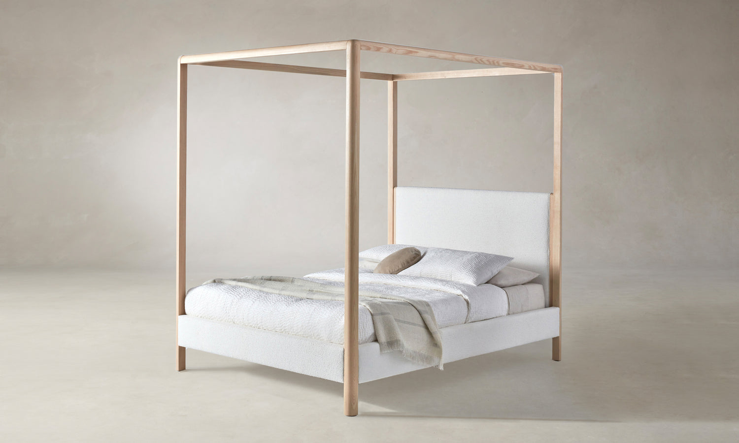 thompson canopy bed upholstered in white boucle with ash wood