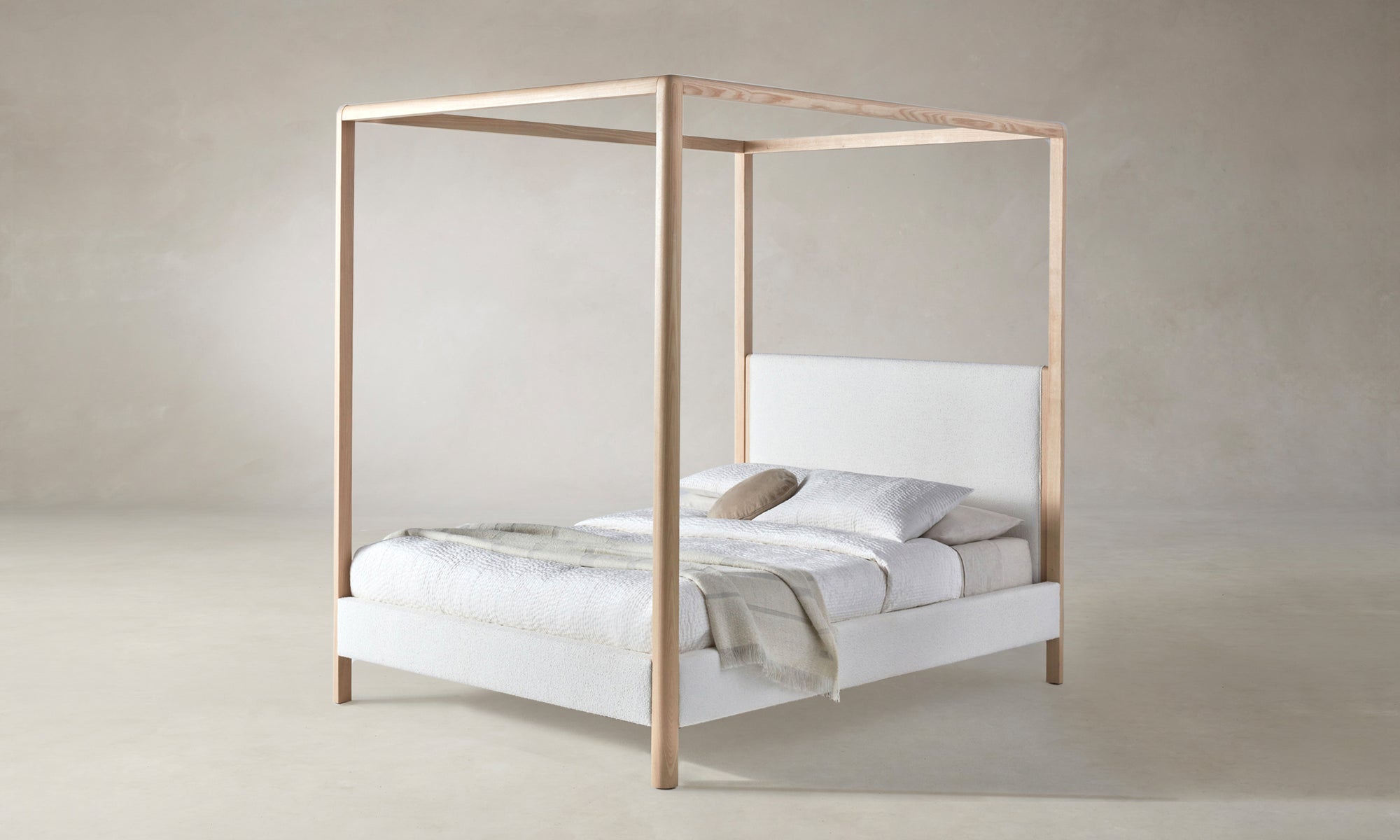 thompson canopy bed upholstered in white boucle with ash wood